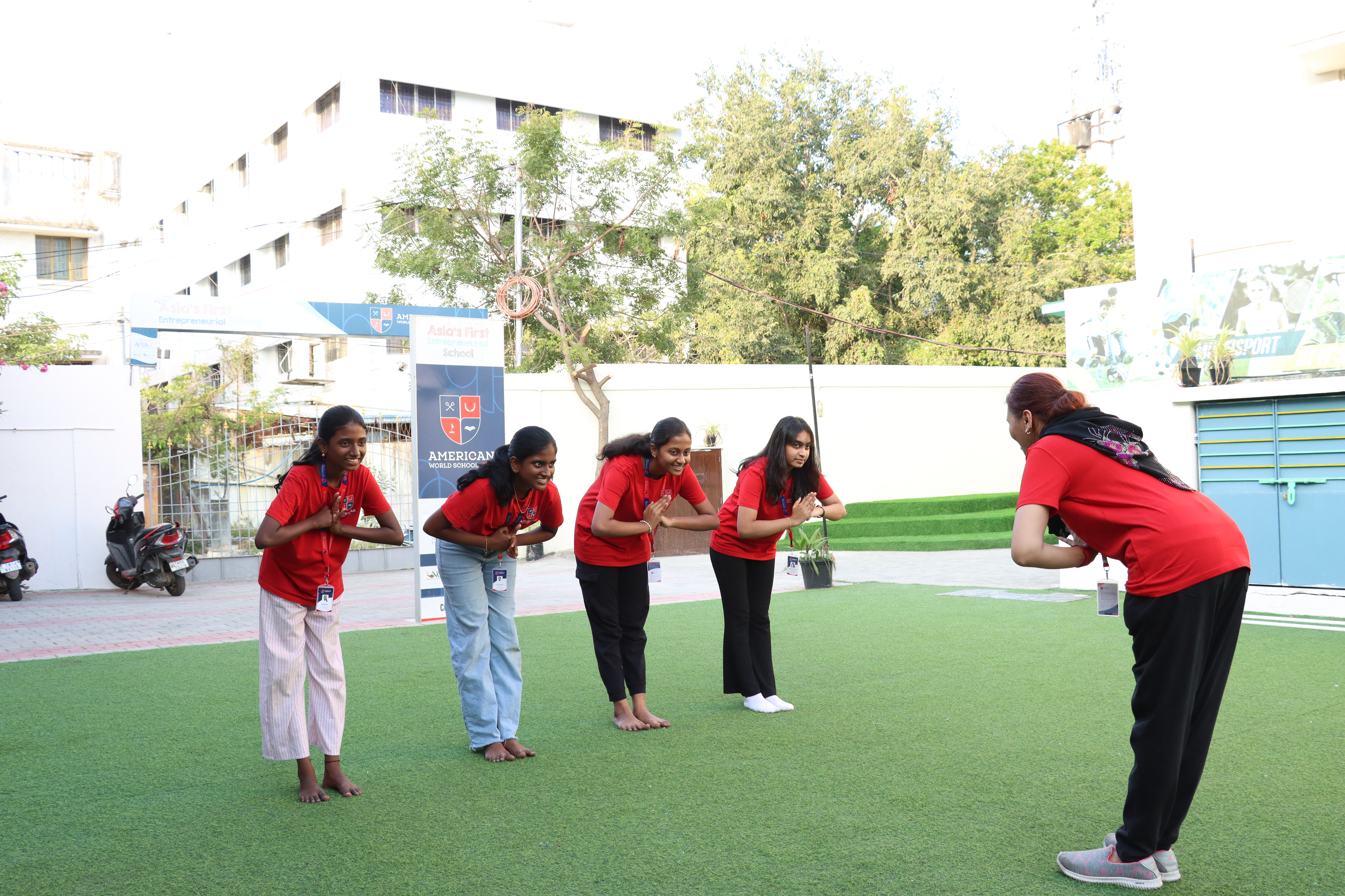 AWS students doing warm-up exercises in the courtyard