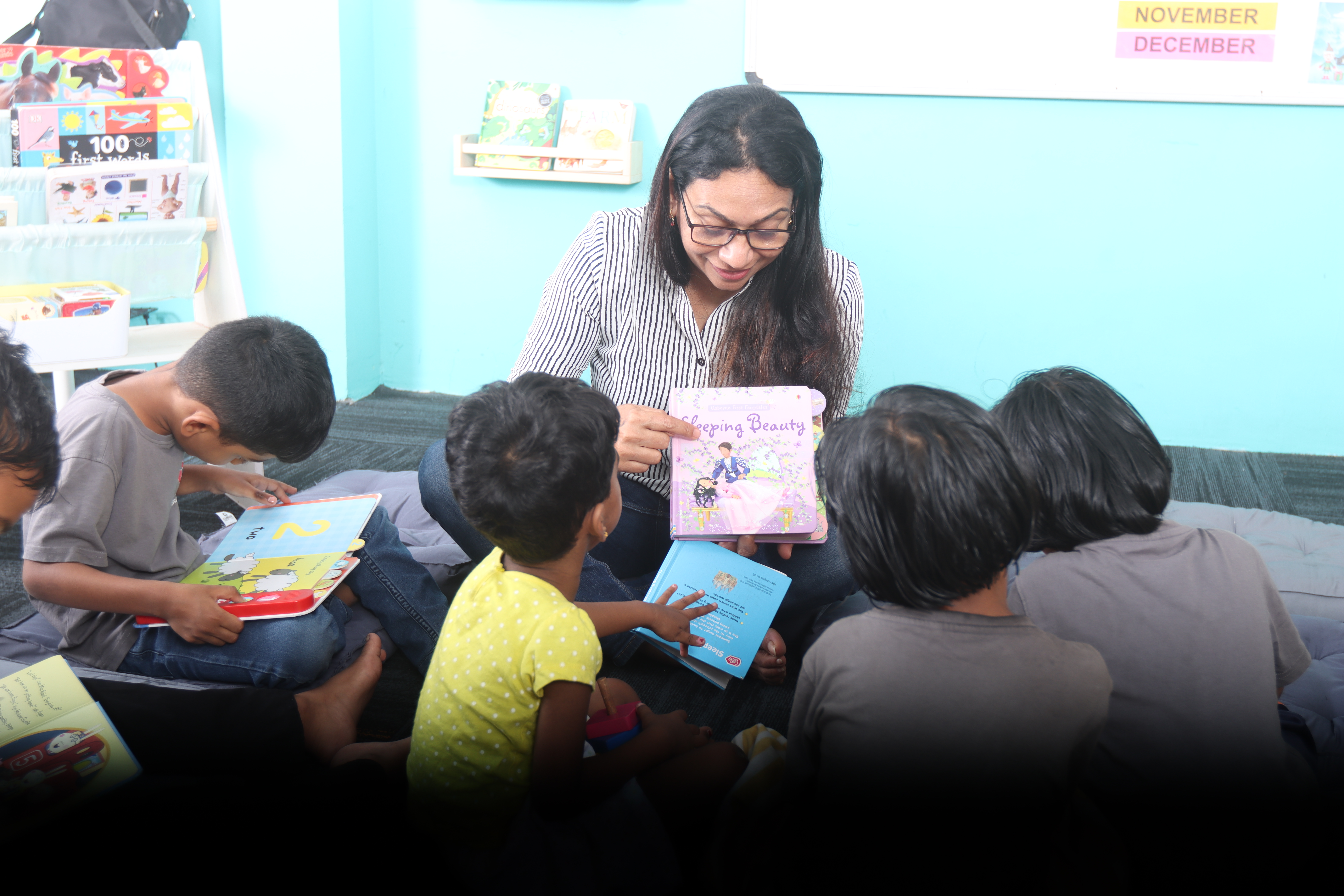AWS teacher reading Sleeping Beauty to a circle of young children