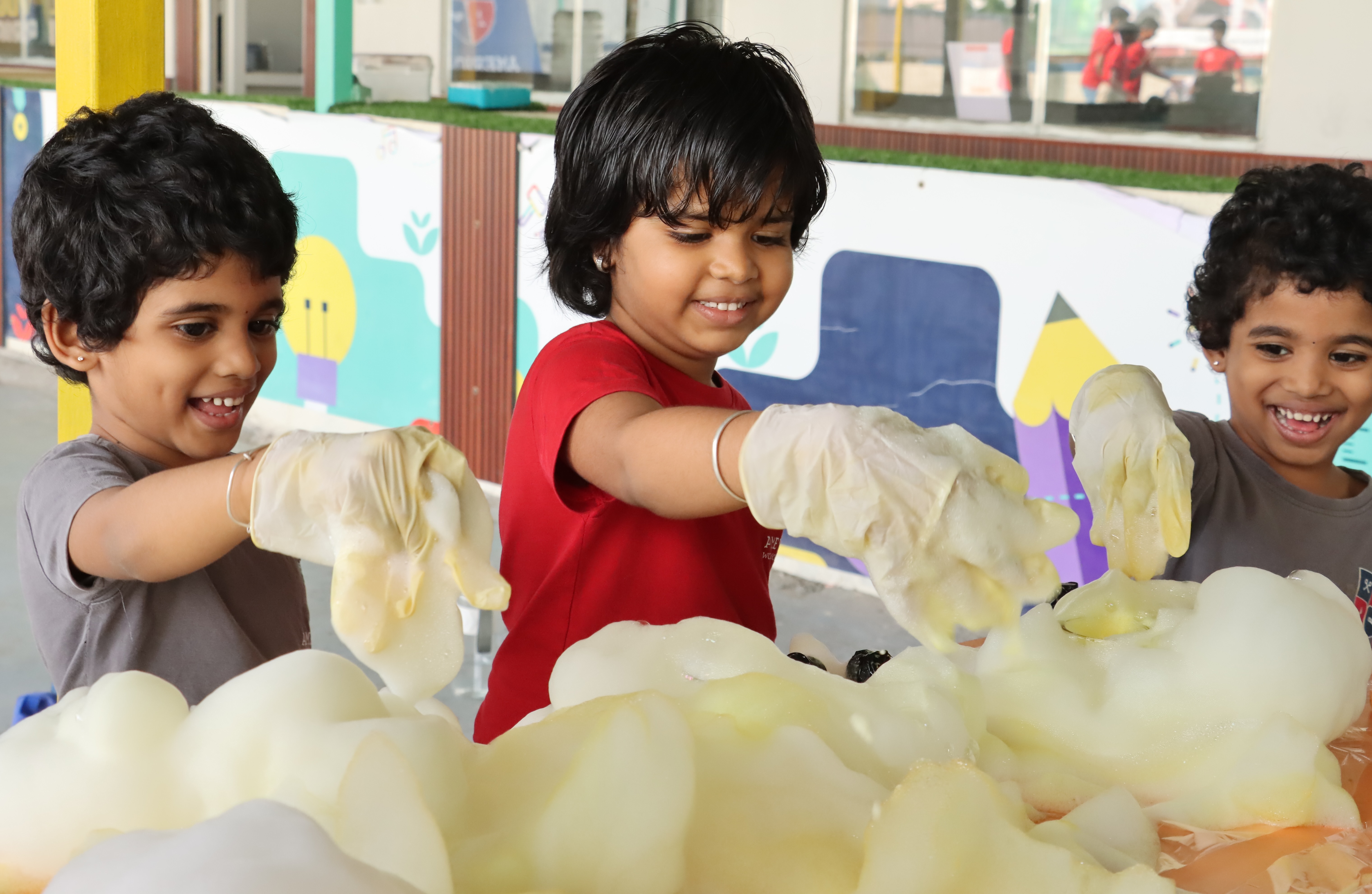 Young children experimenting with soapy foam
