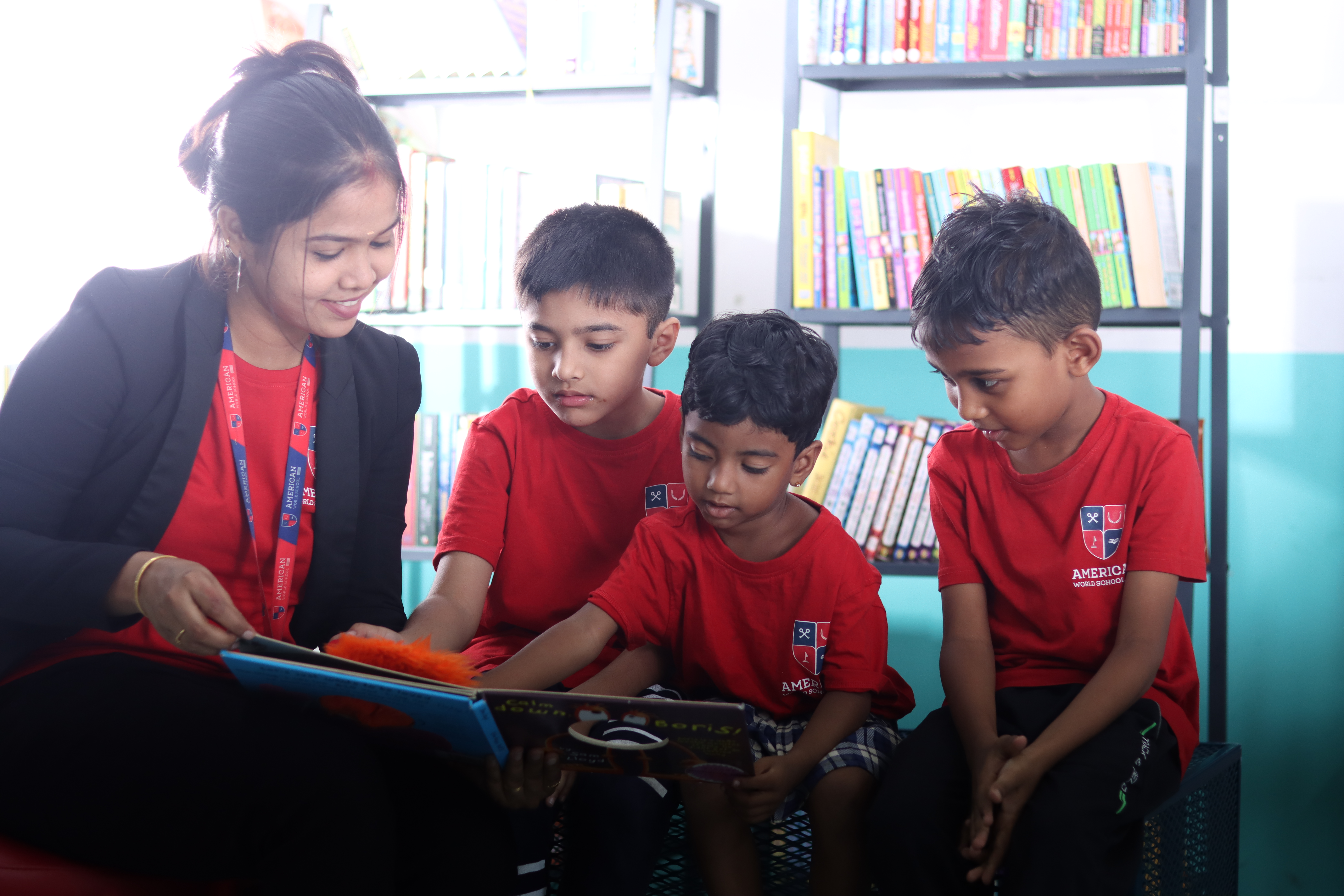 Teacher reading a storybook to young AWS students