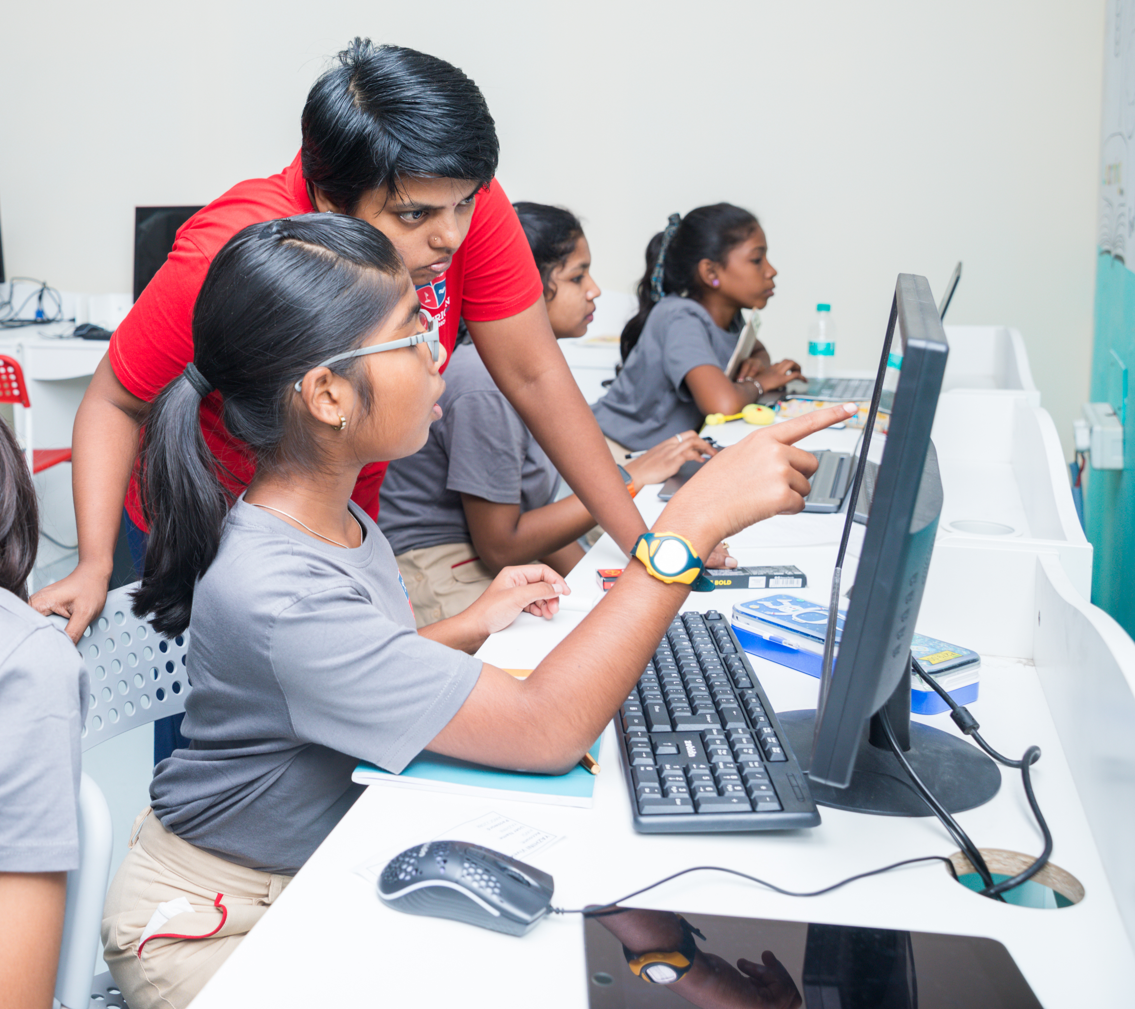 AWS middle school student being mentored at a computer station
