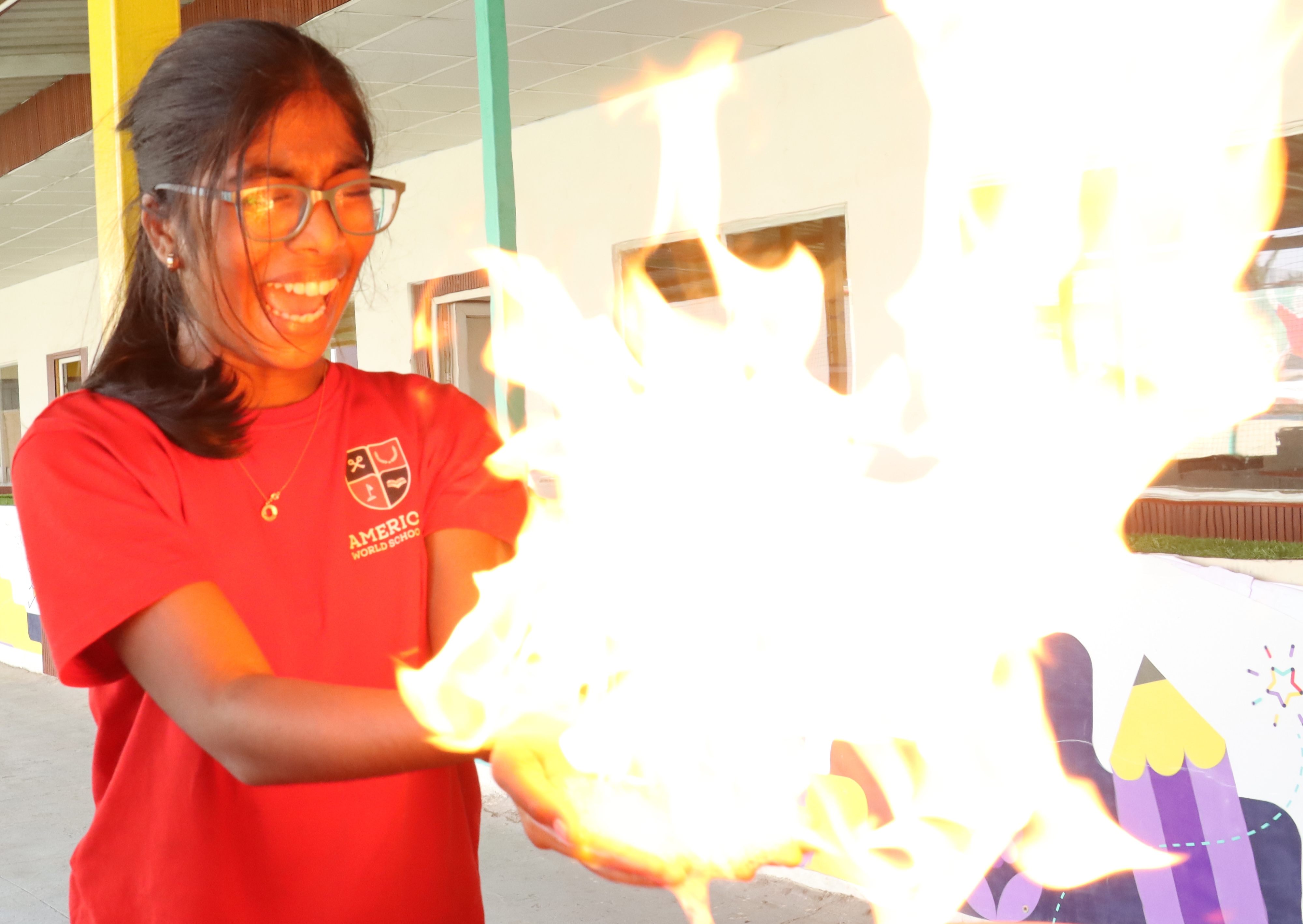 AWS high school student holding a flaming demonstration ball