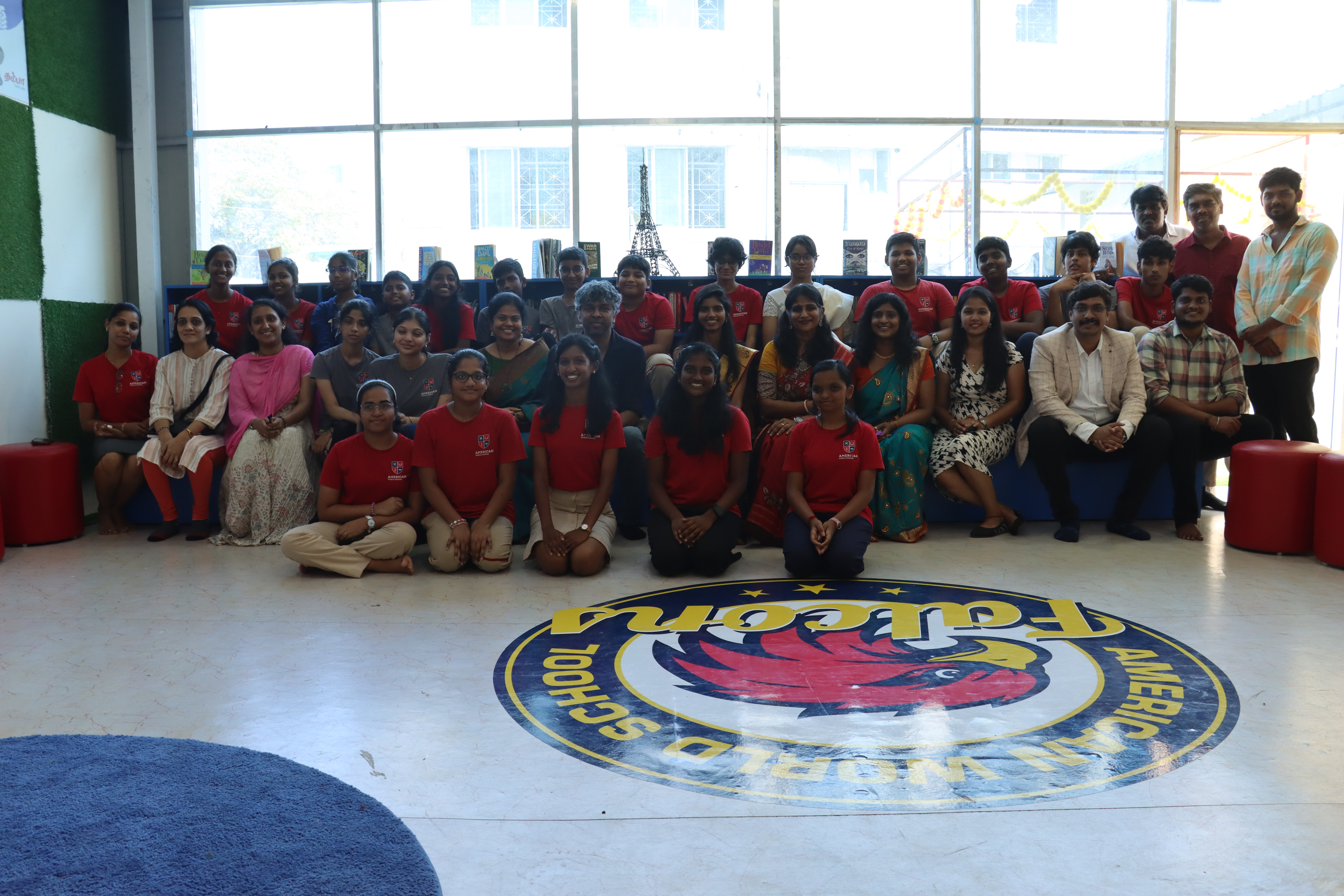 AWS students gathered around the Falcons logo